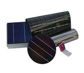 Photo of a blue square with two white vertical lines, a black circular film with three horizontal lines, a metallic cylinder lying underneath the circular film, and a black piece of film that lays above the cylinder.