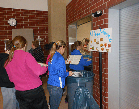 Students diverting food waste instead of throwing it away.