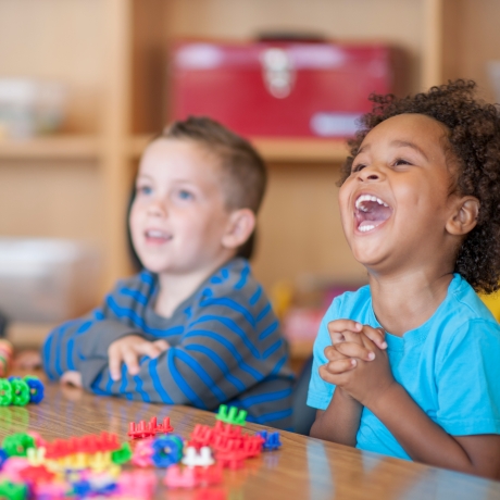 Preschool children laughing, photo by FatCamera/Getty Images