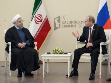 Russia's President Vladimir Putin (R) talks with his Iranian counterpart Hassan Rouhani as they meet during a summit of Caspian Sea regional leaders in the southern city of Astrakhan September 29, 2014