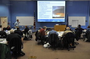 Photograph of an EMI classrom with instructor at front and students seated at tables.