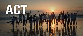 Crowd of people jumping on beach at sunset