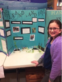 Science Fair participant : Anastasia Kaldy in front of her group’s project – effects of soil types