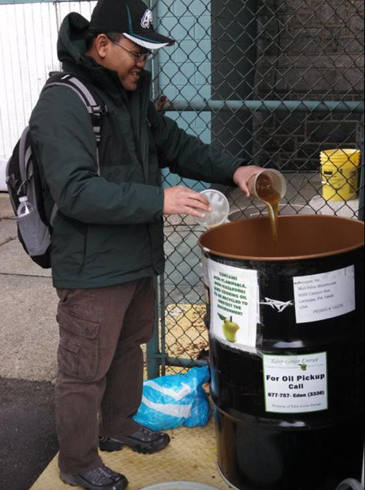 Father Didik of St. Thomas Aquinas church is one of the 15 Barrel Keepers who manage the system of oil collection barrels. The oil he's pouring will become biofuel, compost, and soap.