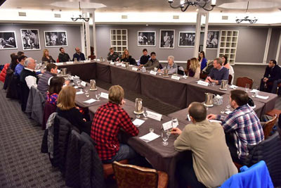 Admininstrator McCarthy and others sitting at round table discussion.