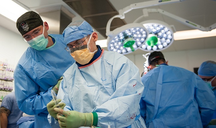 U.S. Airmen assigned to the 455th Expeditionary Medical Group perform trauma surgery on a gunshot victim at the Craig Joint Theater Hospital, Bagram Air Field, Afghanistan. 