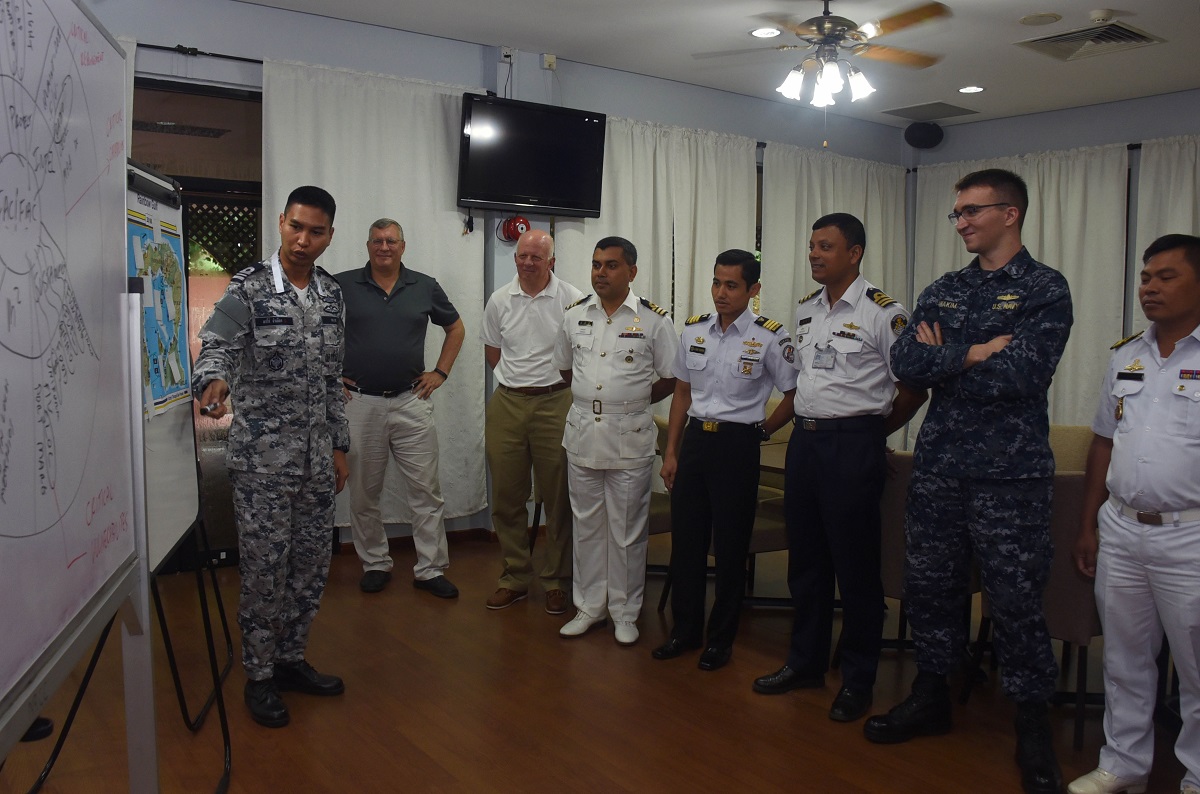 SINGAPORE (Aug. 16, 2016) Liaison officers from participating countries of Southeast Asia Cooperation and Training (SEACAT) 2016 review a training brief to prepare for the exercise at Yankee Station, Aug. 19. SEACAT is multilateral exercise held annually with nine participating countries including the United States, Brunei, Indonesia, Malaysia, the Philippines, Cambodia, Bangladesh, Singapore, and Thailand. U.S. Navy Photo by Mass Communication Specialist 3rd Class Madailein Abbott/Released 