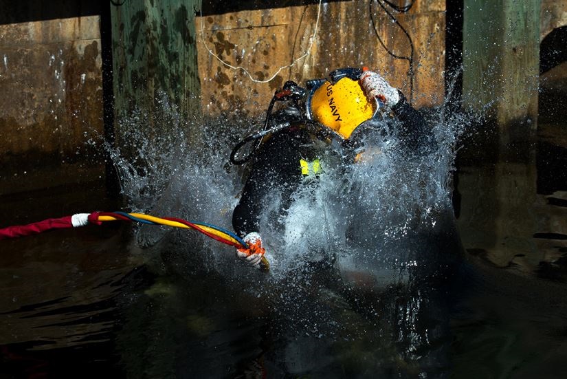 Navy diver Petty Officer 1st Class Jason Fenn enters the water for training in murky water at the Naval Support Activity Panama City in Panama City, Fla., July 14, 2016. Fenn is assigned to the Naval Surface Warfare Center Panama City Division dive locker. DoD photo by EJ Hersom.