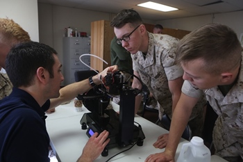 U.S. Marines with 1st Maintenance Battalion, Combat Logistics Regiment 15, 1st Marine Logistics Group, 1 Marine Expeditionary Force, learn from Mr. Nick Mazurek with Inventor Cloud, Applied Systems and Technology Transfer, as he talks about setting up  an Invent3D printer to print  during  training on Camp Pendleton, CA., March 30th, 2016. The training is part of the Expeditionary Manufacturing Mobile Test Bed (EXMAN) project which is a prototype mobile facility (MOFAC) designed to support the continuous experimentation of advanced manufacturing tactics, techniques and procedures under actual operational or combat conditions. Marine Corps photo by Sgt. Rodion Zabolotniy, Combat Camera 