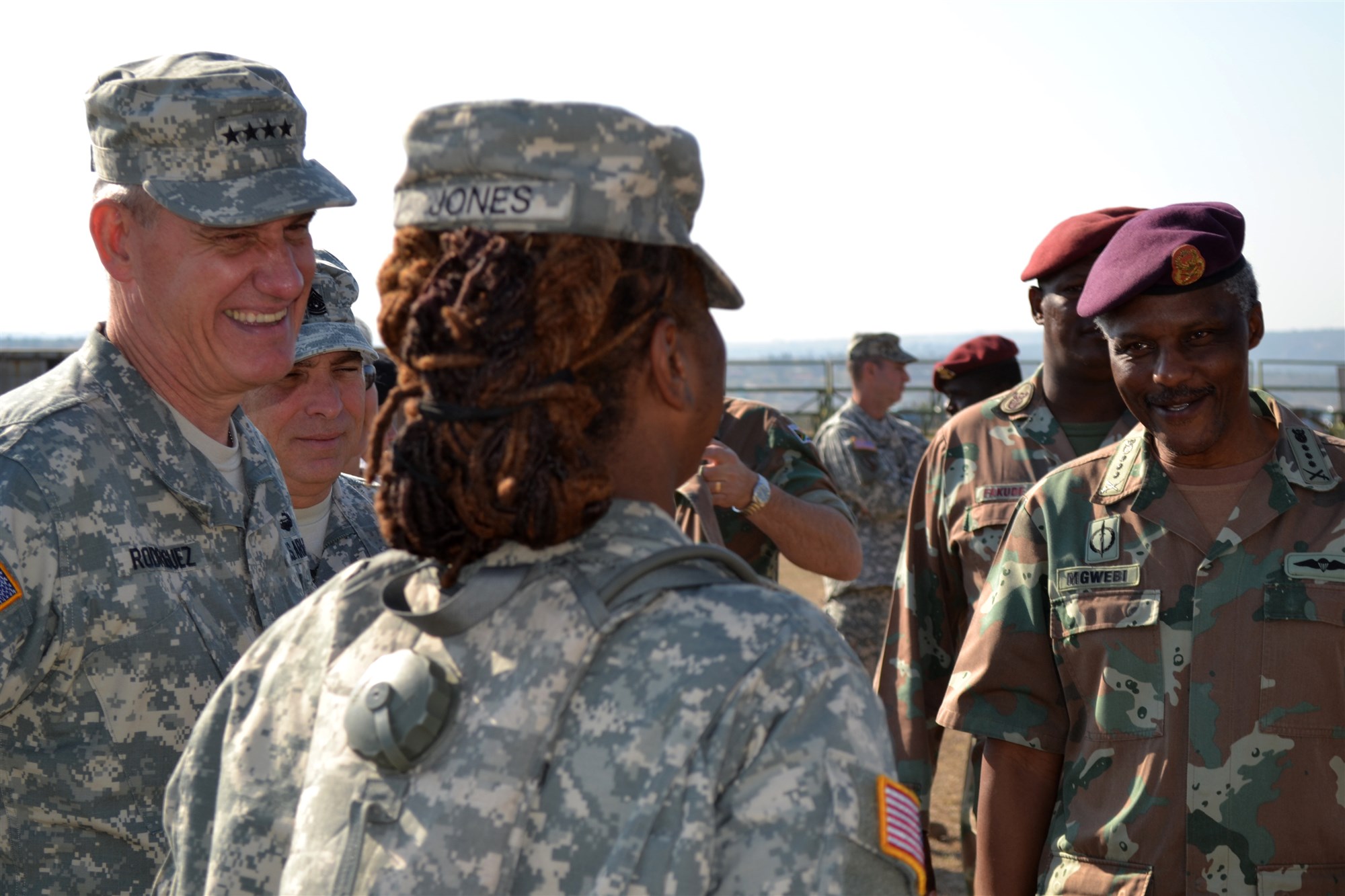 BULEMBU, South Africa— General David Rodriguez, left, commander of U.S. Africa Command, and South African National Defense Force Chief of Joint Operations Lieutenant General Derrick Mgwebi listen as Sergeant  Yvette Jones, a medic with the District of Columbia Army National Guard, explains her role in the humanitarian civic activity that is a major portion of Shared Accord 13. (U.S. Army Photo by Sergeant Daniel Stoutamire)