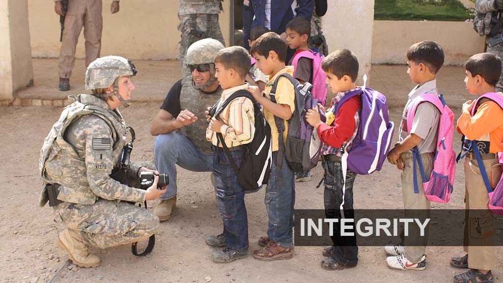 Integrity Overlaid - Balad children receive new backpacks and school supplies from the 37th Engineer Battalion - Joint Task Force Eagle during a Humanitarian Assistance Mission.