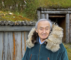 Photo of a man standing outside a lodge.