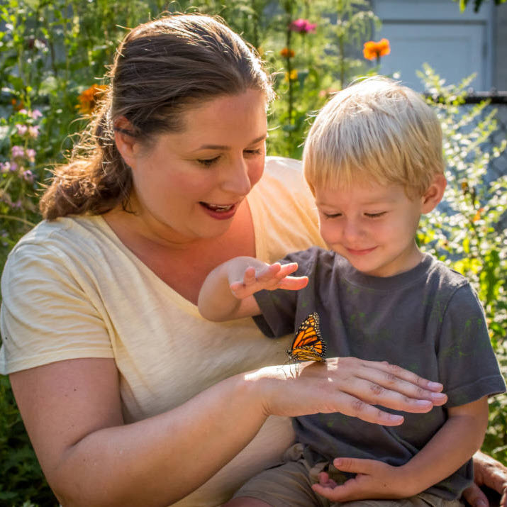 Mother and Child looking at monarch photo