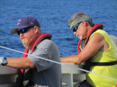 Trey and Kevin Rademacher, fellow fisheries biologist, watch for bait, sharks, and other animals as they haul in the longline. Photo: Matt Ellis/NOAA Fisheries