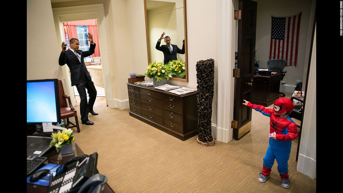 Obama pretends to be caught in Spider-Man&#39;s web as he interacts with Nicholas Tamarin, 3, just outside the Oval Office on October 26, 2012. Nicholas, son of White House aide Nate Tamarin, had been out trick-or-treating. &quot;The President told me that this was his favorite picture of the year when he saw it hanging in the West Wing a couple of weeks later,&quot; White House photographer Pete Souza said.
