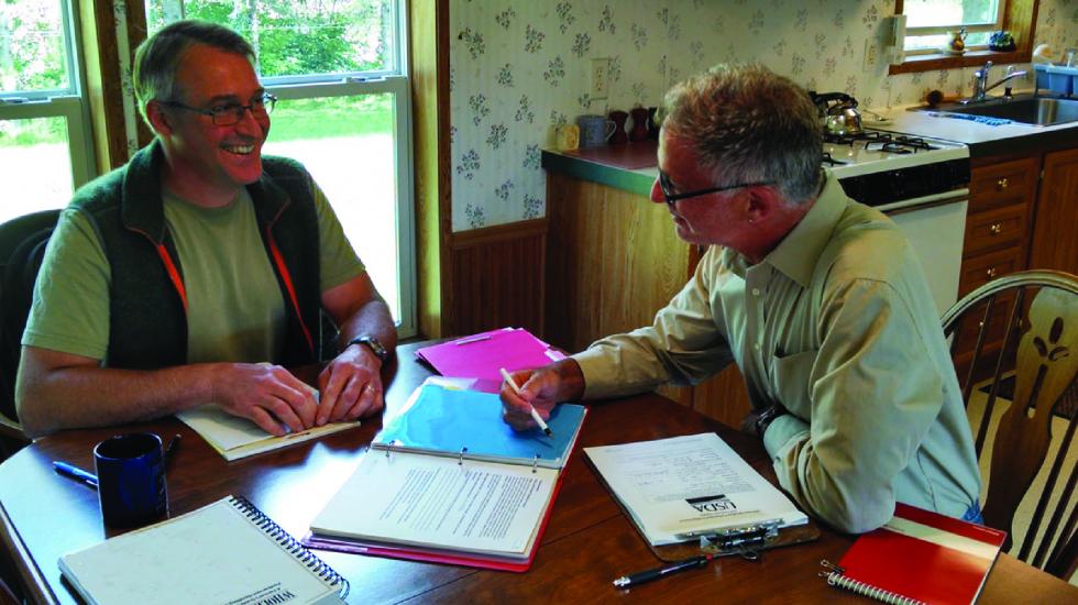 A grower and an internal auditor look over records during a Good Agricultural Practices (GAP) audit. 