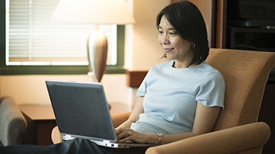 Woman reading fees information online