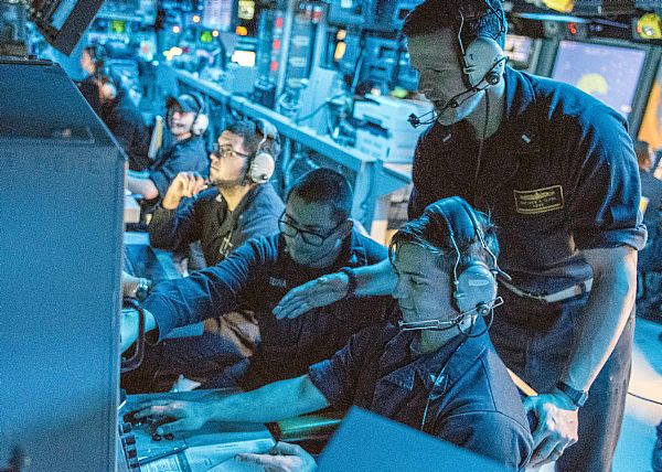 Lt. j.g. Matthew Clark, assigned to the Arleigh Burke-class guided-missile destroyer USS Mahan (DDG 72), talks to sonar technicians about attack options during anti-submarine warfare training. Mahan is deployed in the U.S. 5th Fleet area of operations in support of maritime security operations and theater security operation efforts.  U.S. Navy photo by Mass Communication Specialist 1st Class Tim Comerford (Released)  170117-N-CS953-071