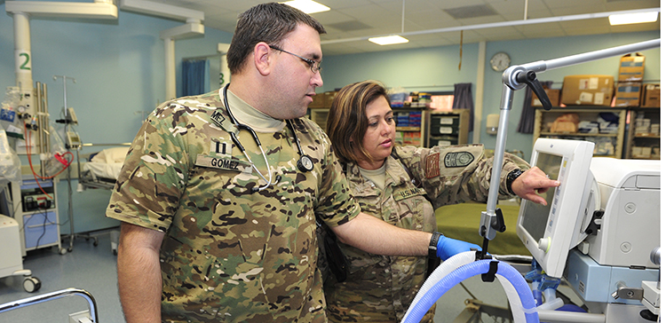 NOSC Tampa and San Diego Sailors calibrate a ventilator at Role 3 Multinational Medical Unit, Kandahar Airfield June 25, 2015