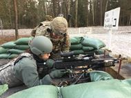 Olympic Gold Medalist Maya DiRado fires an M240 machine gun at a range at Grafenwoehr, Germany, Dec. 8, 2016. The swimmer is part of a USO tour to the Middle East and Europe. DoD photo by Jim Garamone 