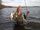 A happy angler, Dianne Kolodziejski a resource manager at Mosquito Creek Lake, displays the catch of the day at Shenango Lake. 