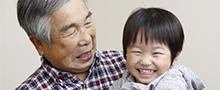 Grandfather and grandson smiling