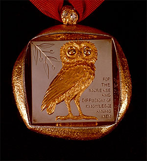 Badge of Office with owl and mission statement.