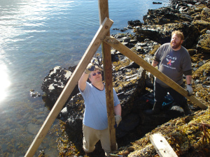 Cheif Survey Tech Jim Jacobson and Assistant Survey Tech Thomas Burrow install the Terror Bay tide staff during low tide.