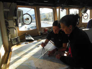 ENS Deveraux showing me how she is plotting a course to our research area.