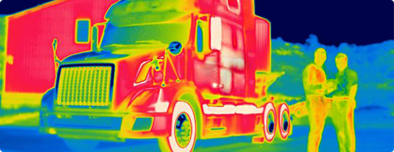 Thermal image of two men standing in front of tractor trailer cab.