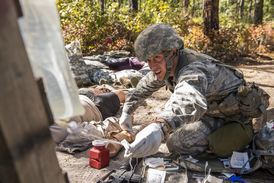Capt. Richard Pate, a Walter Reed National Military Medical Center nurse, checks an IV for a simulated patient during an Expert Field Medical Badge competition at Joint Base McGuire-Dix-Lakehurst, N.J., Oct. 6, 2015. The competition candidates had to run through a tactical combat care course while evading simulated attacks and attending to patients. (U.S. Air Force photo/Senior Airman Tara A. Williamson)