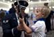 Senior Airman Angelo Hightower, an U.S. Air Force Honor Guard Drill Team member, lets a young boy hold a drill rifle at the Live on Green event in Pasadena, Calif., Dec. 30, 2016. The M-1 Garand rifles weigh about 12 pounds and have dull bayonets attached at their tips. (U.S. Air Force photo/Senior Airman Philip Bryant)