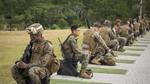 Marines from various units within Okinawa prepare for their turn to fire the table two portion of the annual rifle range qualification, Jan. 12, 2017, at Camp Hansen, Okinawa, Japan.  The Marine Corps revised table two of the marksmanship program October 2016 to increase marksmanship skill and realism in a combat environment. The Corps requires Marines to annually qualify at the range to determine their marksmanship skill. 