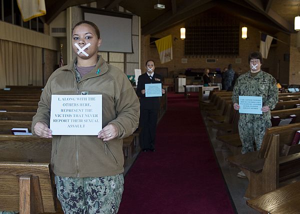 Operations Specialist 2nd Class Ayisha Lanford, a victim advocate for Assault Craft Unit 4, along with victim advocates from other commands, portray silent victims who never report sexual assault crimes, during a Sexual Assault Awareness Month presentation at the Joint Expeditionary Base Little Creek-Fort Story base chapel. The event featured keynote speaker, Antwone Fisher, an American film director, screenwriter, poet, lecturer, professor, best-selling author and former Sailor.  U.S. Navy photo by Mass Communication Specialist 2nd Class Ian Carver (Released)  150402-N-XK513-172