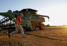 Farmer and tractor (© AP Images)