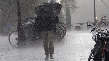 Trekking through heavy rain. 