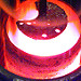 Molten plutonium in a crucible. The improved processing of old plutonium generates less than half of the waste of the former process.