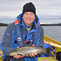 Martin Forsius posing in boat with fish he has recently caught