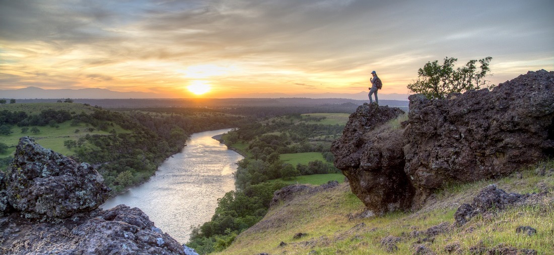 A woman view the sunset over Sacramento River Bend Outstanding Natural Area. Photo by Bob Wick, BLM