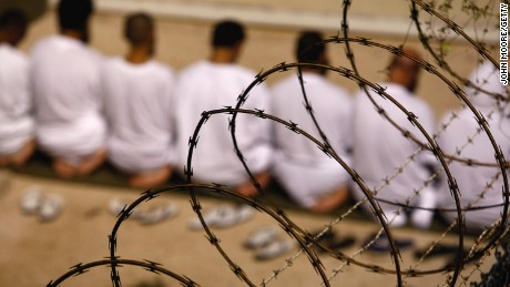 File photo: A group of detainees kneels during an early morning Islamic prayer in their camp at the U.S. military prison for &#39;enemy combatants&#39; on October 28, 2009 in Guantanamo Bay, Cuba. 