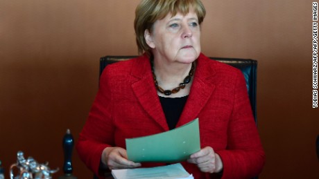 German Chancellor Angela Merkel handles folders at the start of  the weekly cabinet meeting in Berlin on November 9, 2016. handles folders at the start  / AFP / TOBIAS SCHWARZ        (Photo credit should read TOBIAS SCHWARZ/AFP/Getty Images)