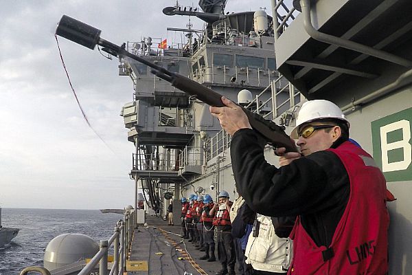  170115-N-UE100-159
ATLANTIC OCEAN (Jan. 15, 2017) Senior Chief Gunner's Mate James Hoppa, assigned to the amphibious assault ship USS Bataan (LHD 5), fires a shot line to make contact with the fleet replenishment oiler USNS Joshua Humphreys (T-AO 188) during a replenishment-at-sea. Bataan is underway conducting composite training unit exercise with the Bataan Amphibious Ready Group in preparation for an upcoming deployment. (U.S. Navy photo by Mass Communication Specialist 3rd Class Caleb Strong/Released)

