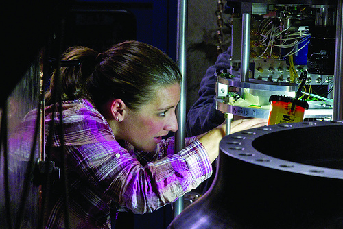 A worker checks a laser diagnostic used on the Barolo subcritical experiment.