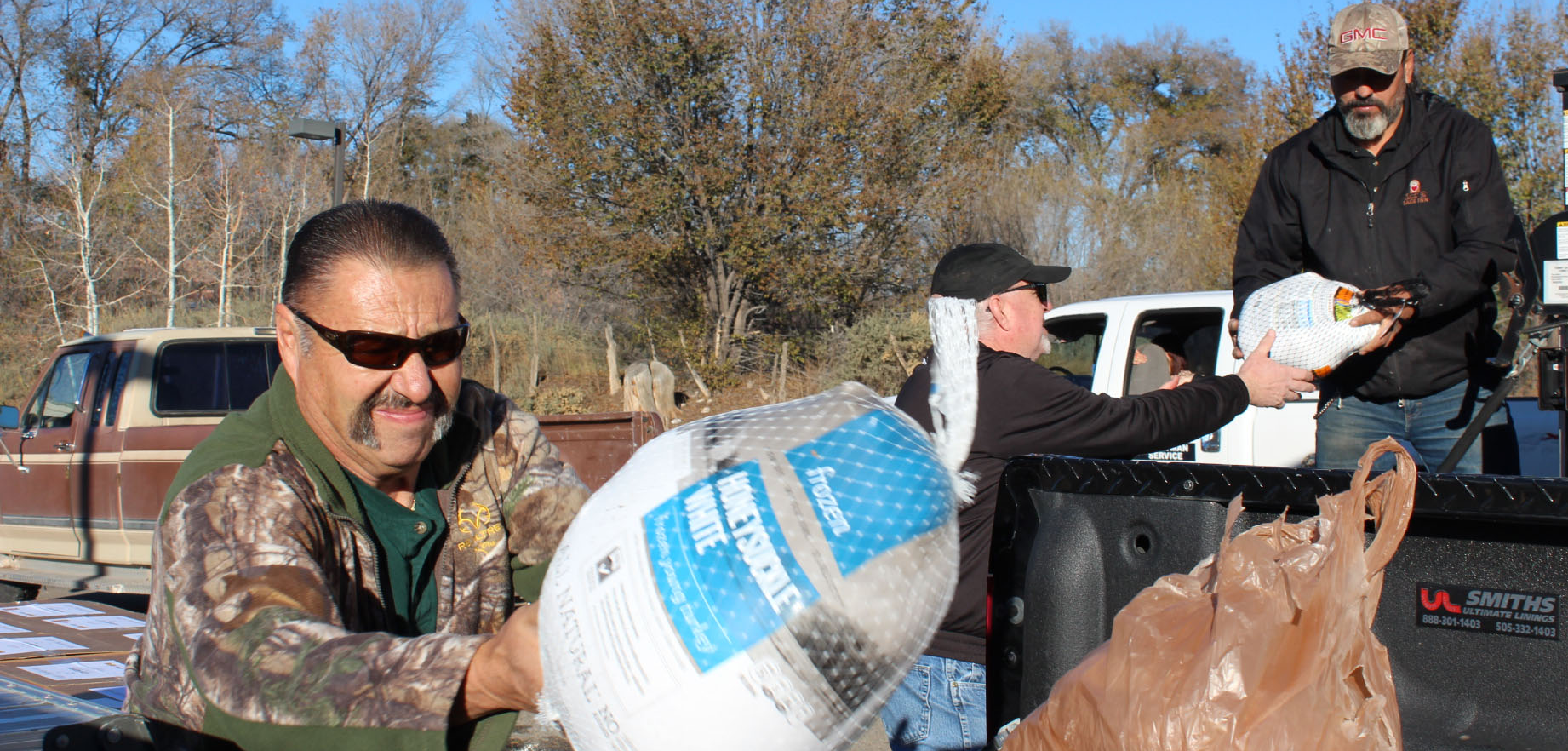 Employees distributing frozen turkeys