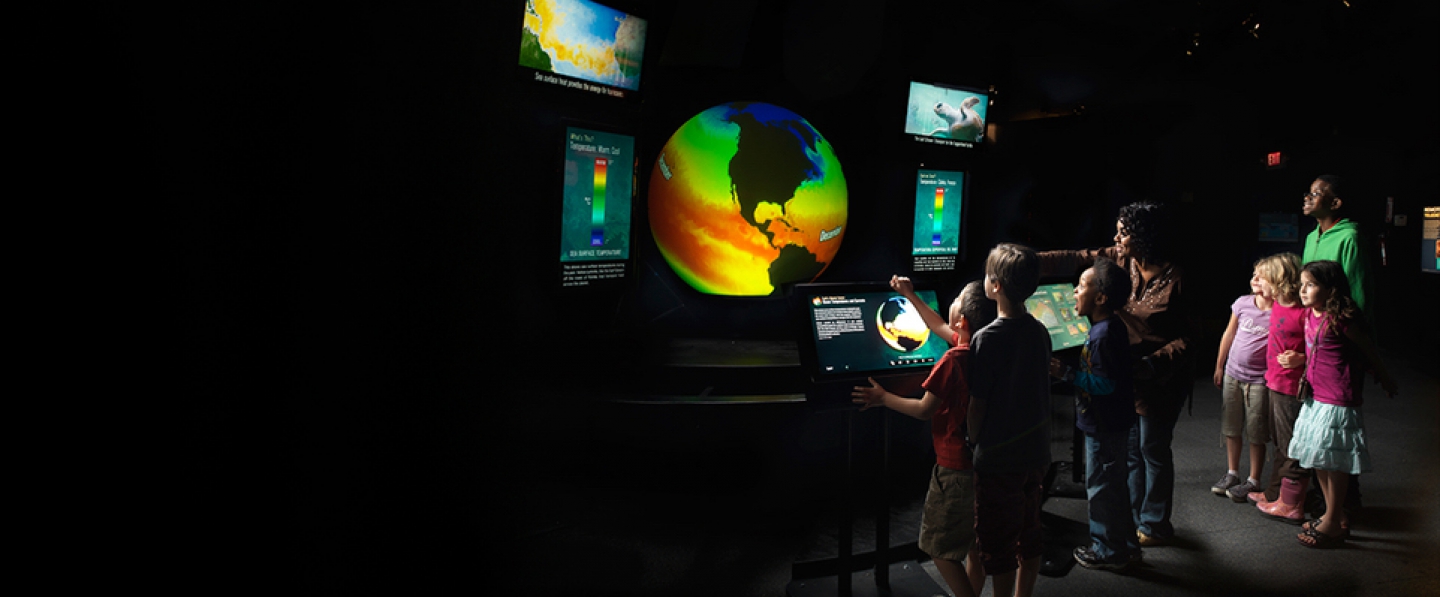 Students and their families explore NOAA data at the Miami Museum of Science.