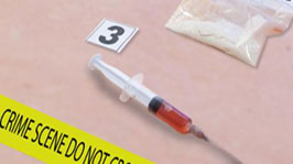 	Image of a hypodermic needle and powdered fentanyl  in the background