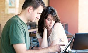 man and woman on computer