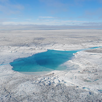 melting pond of water on top of the Arctic sea ice