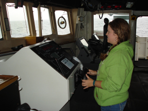 I even felt safe when they let me man the helm (steer the ship).  Out of picture, Officer LTJG Adam Pfundt and Able Seaman Robert Steele guide me through my first adventure at the helm! 