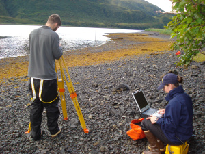 Assistant Survey Tech Eli Smith sets up for a level run while ENS Micki Ream prepares for data collection. 
